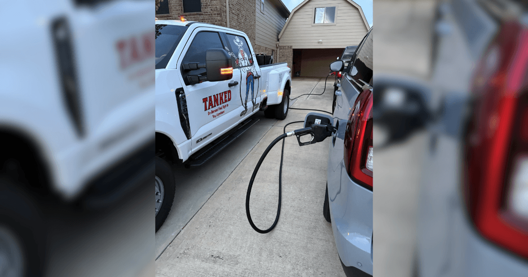 White "Tanked" fuel delivery truck refueling a car in a driveway via a hose and nozzle.