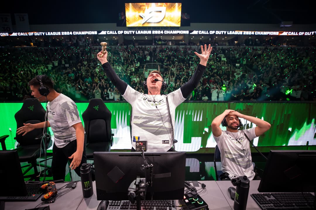 Esports players celebrate winning Call of Duty League 2024 Championship before a large arena crowd.