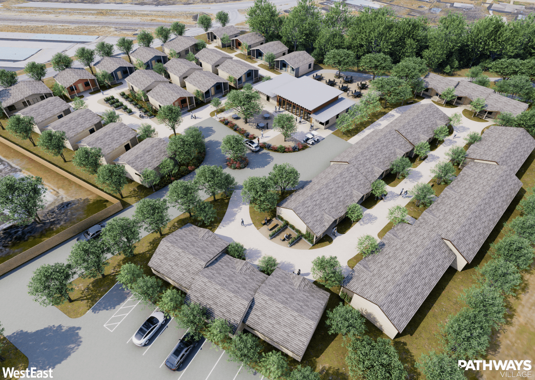 Aerial rendering of Pathways Village, a community of small cottages, walkways, trees, and a central pavilion with parking.