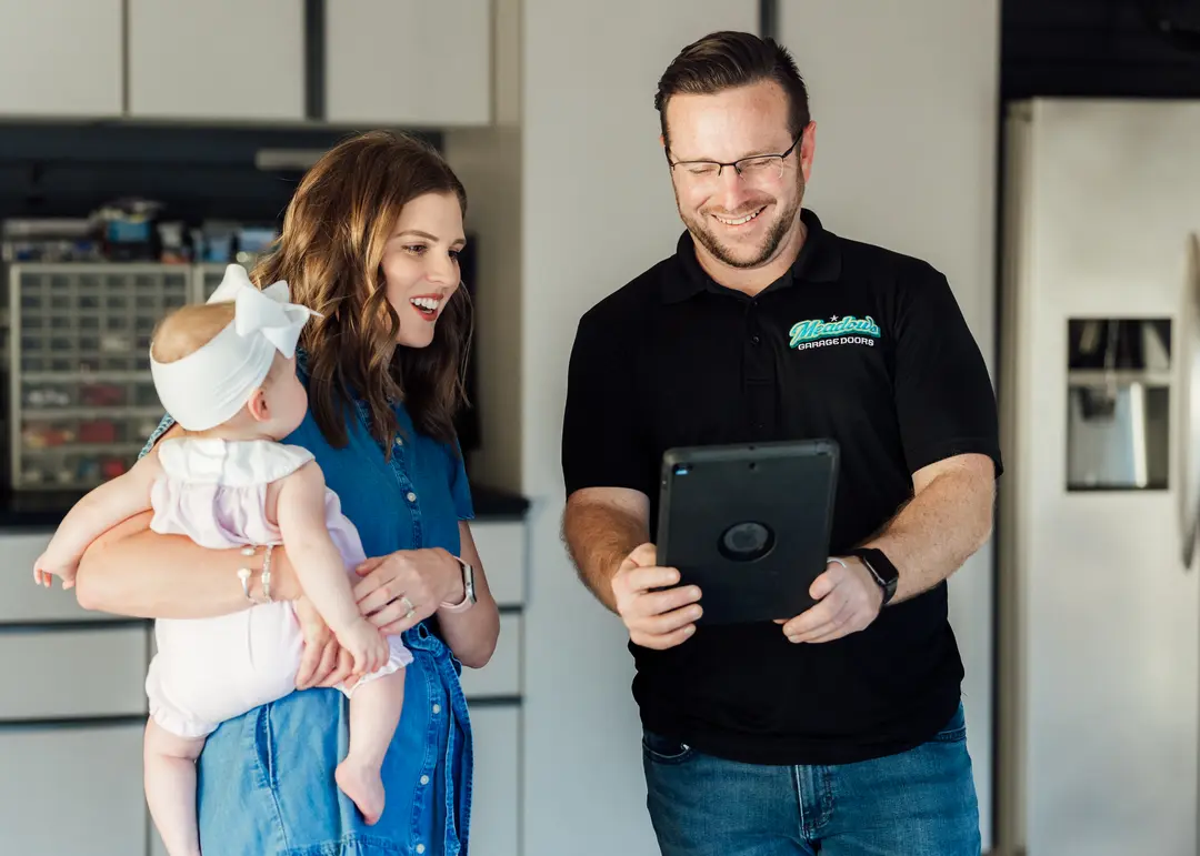 garage door technician showing customer report on an ipad
