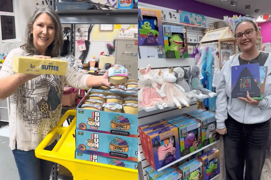 Two women in a toy store hold up novelty products, including a butter-shaped item, slime, and a children's book.