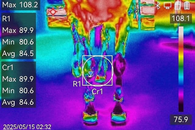 Thermal camera image showing temperature readings with max 108.2°F, displaying heat patterns in blue, purple, green, and yellow colors.