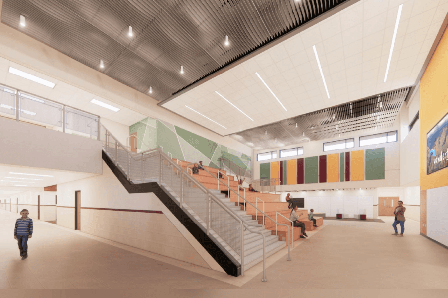 Rendering of modern school interior with wide stepped seating, staircase, and colorful wall panels.