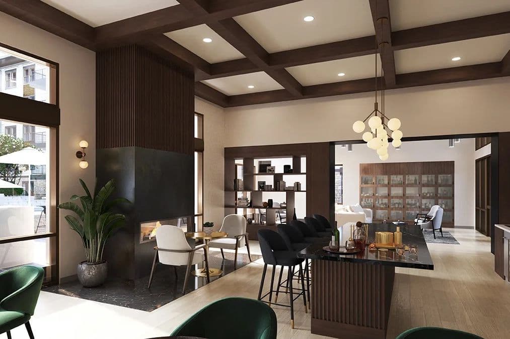 Modern lounge with coffered ceiling, fireplace, marble bar with stools, chandelier, and seating area.