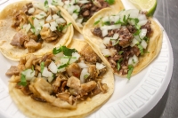 Tacos El Primo serves tacos with a variety of meats, including asada, pastor, cabeza, lengua, buche and carnitas. (Evelin Garcia/Community Impact Newspaper)