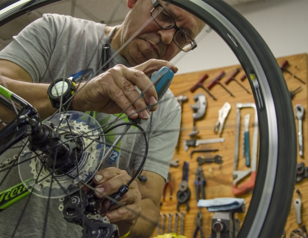 Nelo Breda, owner of Nelo's Cycles and Coffee, works on a repair.