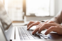 hands typing on a laptop keyboard fotolia stock image