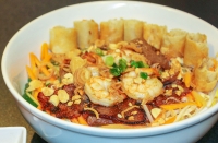The Vermicelli Boom Cha Y’all ($11.95) contains beef, shrimp and egg rolls, served with a sweet and spicy fish-based sauce. (Adriana Rezal/Community Impact Newspaper)