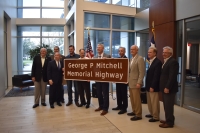 J.J. Hollie, The Woodlands Area Chamber of Commerce president (center) is flanked by Montgomery County officials, representatives and community members at the dedication of a portion of I-45 on Jan. 17. (Vanessa Holt/Community Impact Newspaper)
