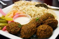The falafel plate ($13.99 comes with tahini sauce and two sides. (Makenzie Plusnick/Community Impact Newspaper)