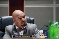 Conroe ISD board President Datren Williams listens to a public comment. (Andy Li/Community Impact Newspaper)