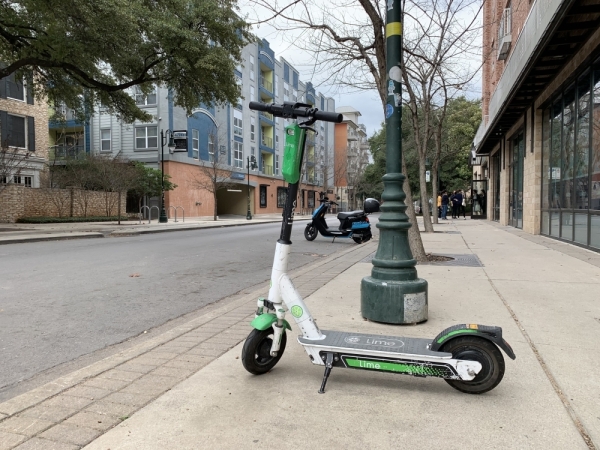 New dockless vehicles, such as Revel mopeds, have entered the Austin market, in addition to electric scooters, pictured here in West Campus. (Emma Freer/Community Impact Newspaper)