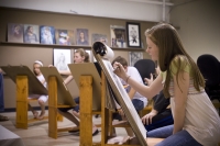 A photo of young adults creating artwork.