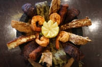 Lalo’s Molcajete includes beef, chicken, shrimp, Mexican sausage, Mexican cactus and cheese served in a molcajete with hot sauce and the diner’s choice of rice and beans. (Shawn Arrajj/Community Impact Newspaper)