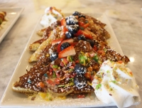 Fruity Pebbles French Toast ($11.99) consists of sourdough bread coated with Fruity Pebbles and drizzled with vanilla cream sauce.