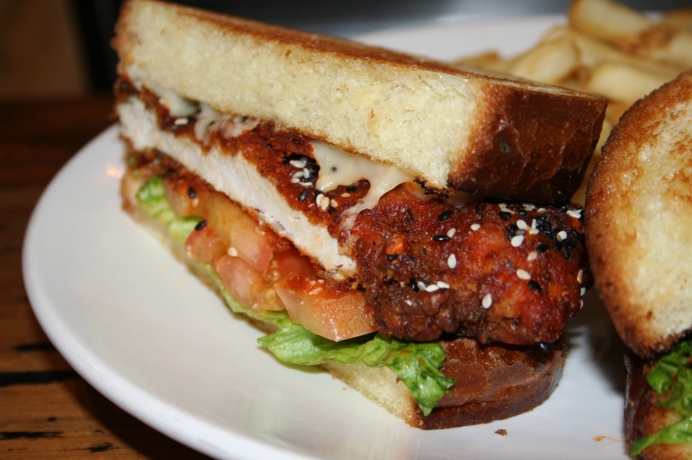 One of owner Benny Polisi’s personal favorites is the buffalo chicken burger ($8.99), which he makes with Swiss cheese, lettuce, tomatoes and brioche bread. (Renee Yan/Community Impact Newspaper)