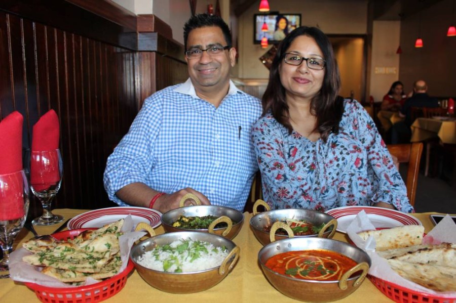 Deepak and Ritu Nagpal, owners of Indian restaurant Kurry Walah, sit at a table at the eatery's Katy location. (Nola Z. Valente/Community Impact Newspaper)