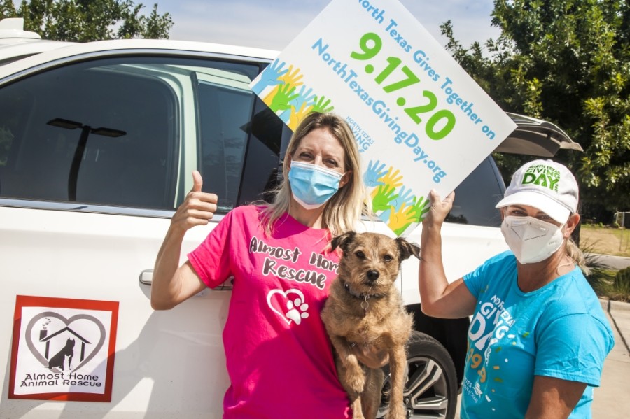 Almost Home Animal Rescue's Heather Weeks, left, and Amy Desler pick up North Texas Giving Day yard signs. (Courtesy Kim Leeson/Communities Foundation of Texas)