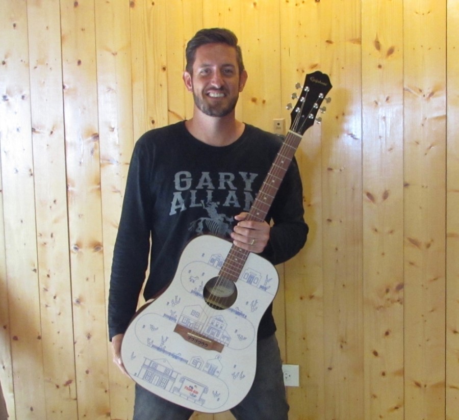 Scott Friedeck, owner of The Graphic Guitar Guys, started working with guitars in 2011. (Nicholas Cicale/Community Impact Newspaper)