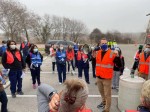 Photo of Judge Brown in a mask and orange vest with megaphone