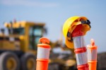 Traffic cone, hard hat, construction equipment, motor grader. (Courtesy Fotolia)