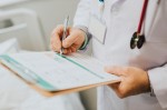 A doctor holding a clipboard