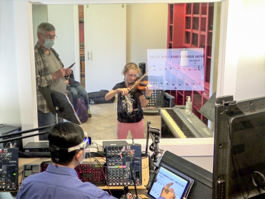 Allegro Violin School founder Chaiwat Rodsuwan is able to teach students from a separate room with the help of technology. (Courtesy Allegro Violin School)