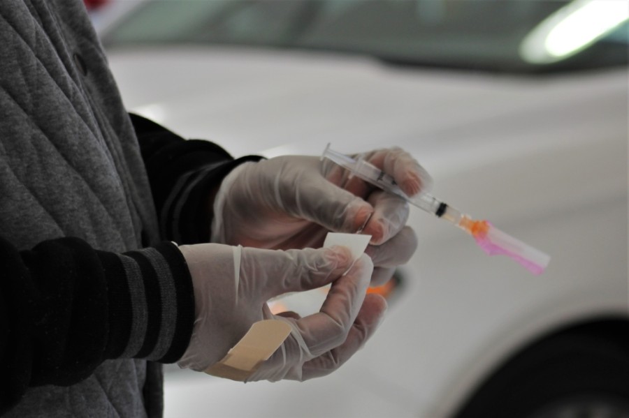 Photo of hands holding a vaccine vial