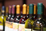 A row of wine bottles in a store.