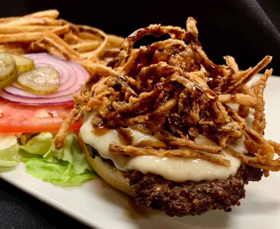 The Cool Cafe Burger ($14) features a cast-iron cooked beef patty topped with fried onions, provolone cheese and a housemade steak sauce. (Courtesy Cool Cafe)