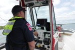 Lewisville firefighter Mike Farley operates a boat.