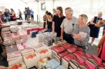 Photo of shoppers eyeing a table of books