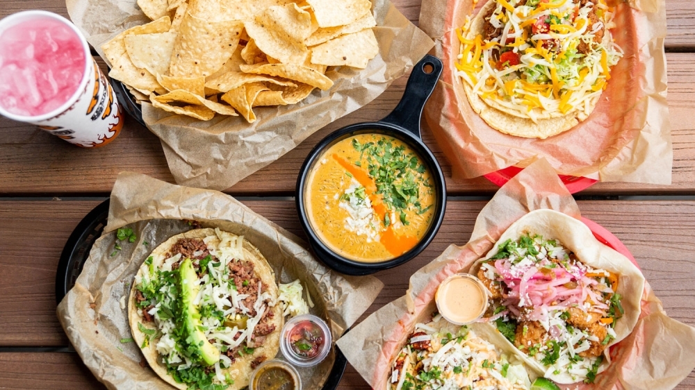 spread of tacos, chips and queso