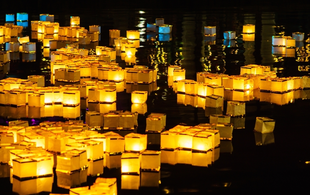 water lanterns float on a lake