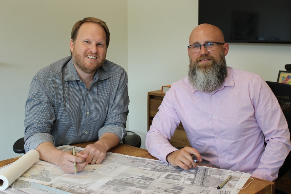 Kobey Seale (left) and Eric Ciskowski, co-owners of Conduit Architecture + Design, pose in their McKinney office. (Brooklynn Cooper/Community Impact Newspaper)