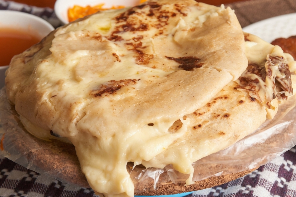 Pupusas are a traditional Salvadorian corncake filled with beans and cheese or meat. (Courtesy Adobe Stock)
