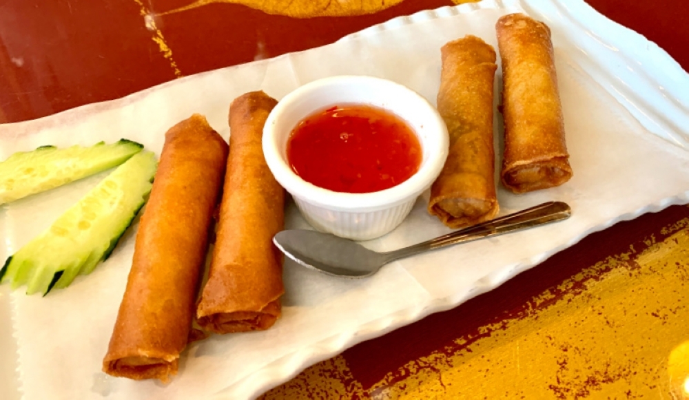 The vegetable spring rolls are stuffed with a shredded taro and served with a sweet and sour sauce. (Ellie Borst/Community Impact Newspaper)