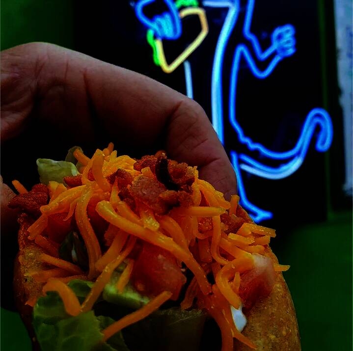 At Blue Gecko, a Texas Taco comes with seasoned ground beef, lettuce, tomato, sour cream, cheese and bacon. (Courtesy Blue Gecko)