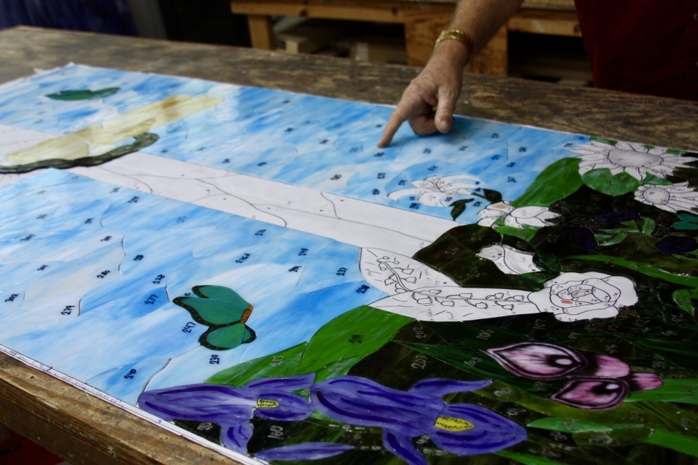 Each piece of glass is cut and arranged in the final pattern to ensure it fits. (Lauren Canterberry/Community Impact Newspaper)