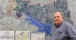 man standing in front of map