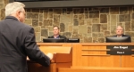 Mayor Derek France and Town Council Member Jim Engel listen to comments from Lewisville ISD Board President Tracy Scott Miller at the Oct. 4 council meeting about the potential for LISD property in Flower Mound. (Samantha Van Dyke/Community Impact Newspaper)