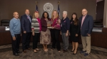 The Humble ISD board of trustees at an Oct. 19 meeting bid farewell to Position 6 trustee Lori Twomey following the announcement of her resignation. From left: Position 2 trustee Robert Scarfo, Position 1 trustee Robert Sitton, Position 3 trustee Chris Parker, board President Martina Dixon, Twomey, Position 7 trustee Nancy Morrison, Superintendent Elizabeth Fagan and Position 4 trustee Ken Kirchofer stand in front the dais as they honor Twomey at her last board meeting. (Courtesy Humble ISD)