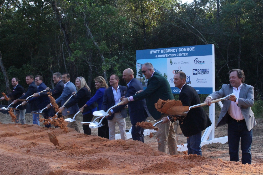 Conroe city government and business officials toss dirt with shovels