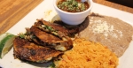 Birria Tacos are served on Tuesdays at Los Compadres. Traditional slow-cooked tender beef in dipped corn tortillas is topped with cilantro and onions. The tacos are served with Mexican beef stew, rice and beans. (Sandra Sadek/Community Impact Newspaper)