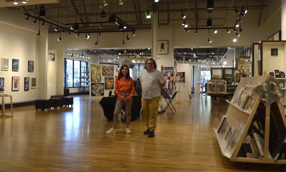 From left, ArtUs Co Gallery Curator Maggie Lyon and Executive Director Joshua Green are preparing the shop and studio space in the Arboretum to welcome visitors during the Austin Studio Tour. ArtUs Co will bring in nearly 30 featured artists for the two-weekend event. (Iain Oldman/Community Impact Newspaper)