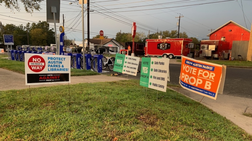Photo of election signs outside Austin's Carver Branch Library