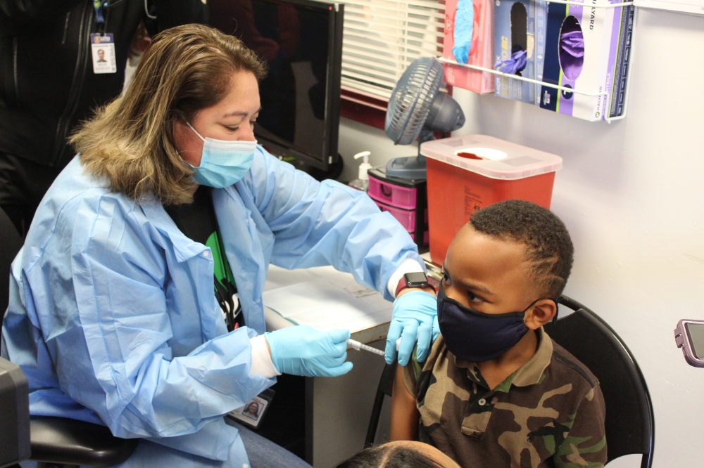 A nurse at Nueva Casa De Amigos in Houston administers a Pfizer coronavirus vaccine to a child on Nov. 5. (Shawn Arrajj/Community Impact Newspaper)