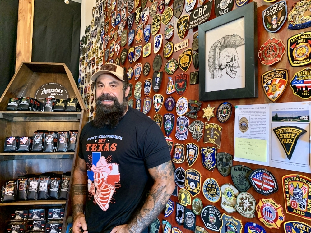 Whitlock's customers who have served in the military often send him patches representing the units in which they served. Whitlock hangs them on what he calls his honor wall. (Greg Perliski/Community Impact Newspaper)
