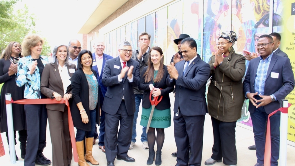 Officials from the University of Houston at Sugar Land, city of Sugar Land, and Fort Bend County as well as artists involved in the project gathered for a ribbon-cutting ceremony for the "Diversity over Division" mural Nov. 4. (Claire Shoop/Community Impact Newspaper)