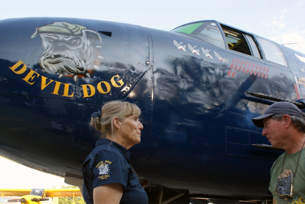 Devil Dog Squadron pilot Beth Jenkins, left, and crew chief Ernie Henderson with the plane at a recent event. (Eddie Harbour/Community Impact Newspaper)